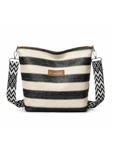Close-up of black and white striped woven tote bag with adjustable geometric wide strap
