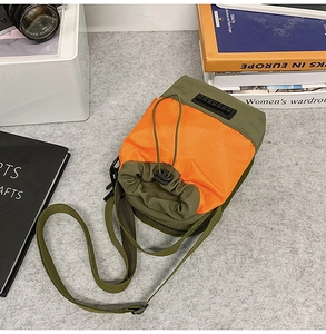 Small Japanese-style green and orange nylon crossbody bag with drawstring closure