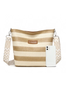 Detail of striped woven tote bag with leather patch and adjustable geometric strap
