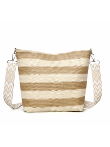 Detail of striped woven tote bag with adjustable geometric patterned shoulder strap