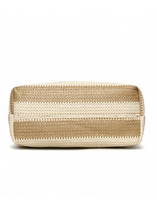 Detailed macro view of woven raffia tote bag showing beige and brown stripe textures