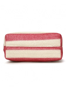 Detailed bottom view of red and white striped woven tote bag showing handcrafted base