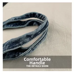 Macro shot of durable denim tote bag handle with reinforced white double stitching