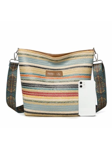 Striped woven shoulder bag detail with leather brand label and patterned strap next to a phone