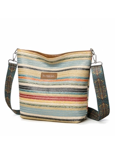 Detail of colorful striped woven hobo bag with patterned strap and leather logo patch