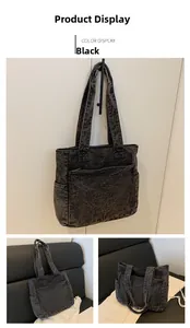 Detail of black washed denim tote bag showing white stitching and large capacity