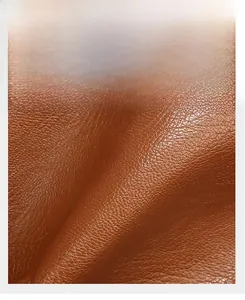 Gros plan détaillé du cuir marron à motif litchi avec une texture douce et polie