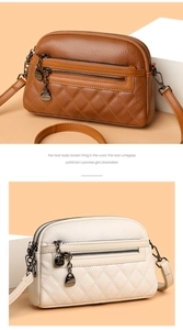 Detail of lychee pattern leather bags with quilted design and multi-layer zippers