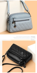 Detail of light blue and black PU leather bags with diamond quilting and multiple zippers