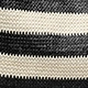 Macro shot of black and white striped woven fabric showing the detailed knit texture