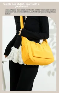 Detailed side view of yellow waterproof nylon tote bag with functional drawstring pocket