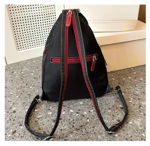 Detail view of anti-theft zipper pocket on black waterproof oxford travel backpack