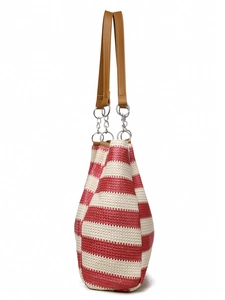 Detail of red and white woven tote bag showing fine fiber texture and brown leather straps