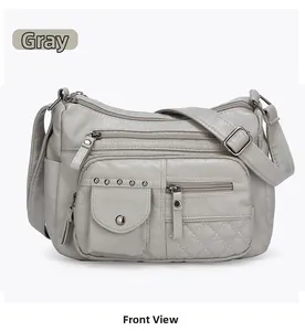 Vue frontale du sac bandoulière en cuir gris texturé avec plusieurs poches zippées