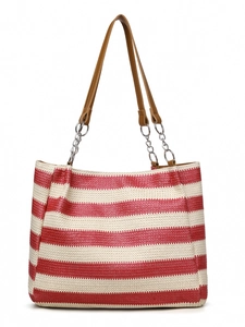 Detail of red and white striped straw tote bag with brown faux leather straps and metal chains