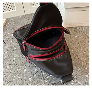 Internal view of waterproof oxford backpack with three zippers and red interior lining