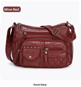 Détail du sac bandoulière bordeaux en similicuir avec multi-poches et texture grainée