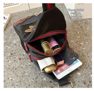 Spacious interior of waterproof nylon chest bag with iPad, phone, and daily essentials