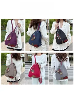 Waterproof nylon backpack shown in six colors with decorative leaf embroidery detail