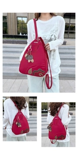 Three-way view of red Oxford backpack with leaf embroidery and dual leather pendants