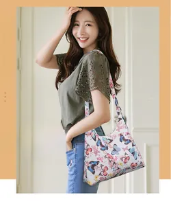 Close-up of mini retro underarm bag with colorful butterfly prints on fabric