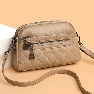 Elegant beige leather crossbody bag with lychee texture and diamond quilted stitching