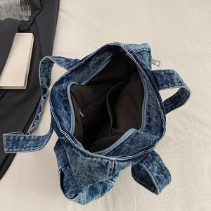 Deep blue denim tote bag interior showing zipper pocket and spacious black lining
