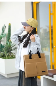 Detailed view of canvas tote bag showing side pockets and premium fabric texture