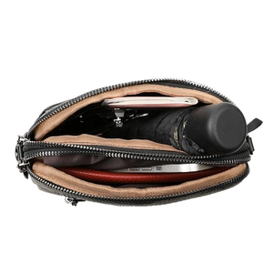 Quilted black crossbody bag with three zipper compartments showing high storage capacity