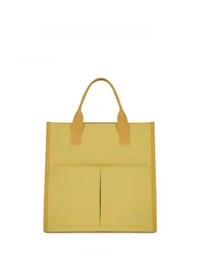 Front view of yellow canvas tote bag featuring two symmetrical outer pockets and dual handles