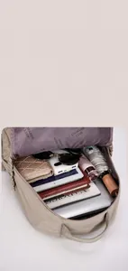 Interior view showing the large capacity and multi-pocket storage of the khaki backpack