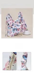 Detail of metal zipper and adjustable buckle on a beige canvas bag with butterfly patterns