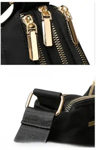 Detail of high-quality gold hardware and zipper on the black nylon crossbody bag