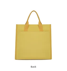 Back view of a yellow canvas tote bag showing stitching details and durable handles