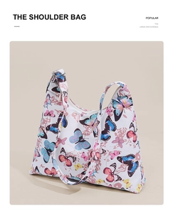 Detail view of canvas shoulder bag with colorful butterfly print and silver buckle