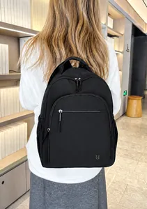 Close-up of lightweight black outdoor backpack with LS logo and front zip pocket