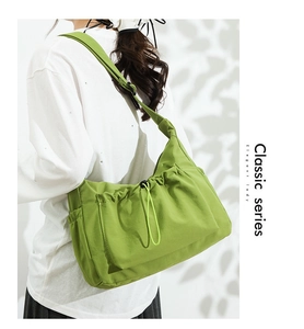 Detail view of grass green canvas tote bag with drawstring texture and wide shoulder strap