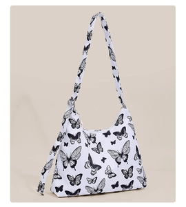 Detail of canvas hobo bag with black butterfly print and adjustable shoulder strap