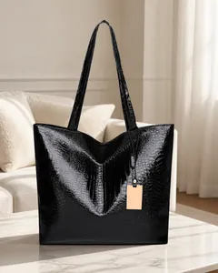 Close-up of black crocodile pattern faux leather texture on a large tote bag
