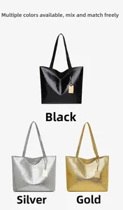 Detail view of large crocodile pattern tote bags in black, silver and gold metallic finishes