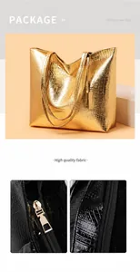 Detailed close-up of golden metal zipper and crocodile embossed texture on a large tote bag