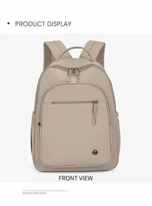 Detail view of the spacious front zipper pocket and round logo on khaki nylon backpack