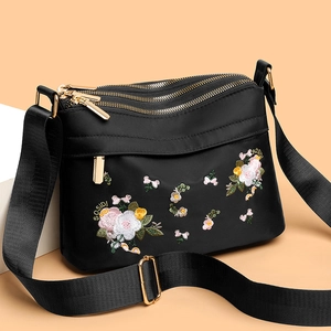 Floral embroidered nylon crossbody bag with multi-zipper compartments and gold hardware