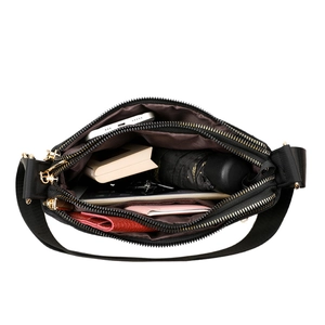 Large capacity black nylon crossbody bag with gold zippers showing multi-pocket storage