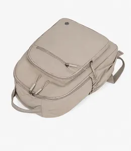 Flat lay of khaki nylon backpack with durable zipper pocket and elastic side pockets