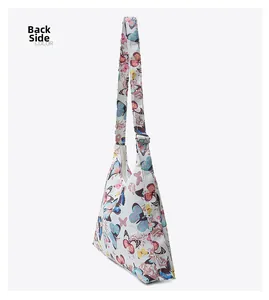 Detailed back view of white butterfly print tote bag with adjustable silver metal buckle