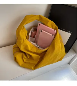 Top view of large yellow tote bag showing interior capacity with tablet and wallet