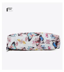 Detailed bottom view of the white shoulder bag with colorful butterfly patterns