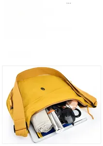 Spacious yellow oxford fabric crossbody bag showcasing storage for tablet and daily items