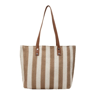 Large striped straw tote bag with khaki stripes and brown leather straps for beach vacation
